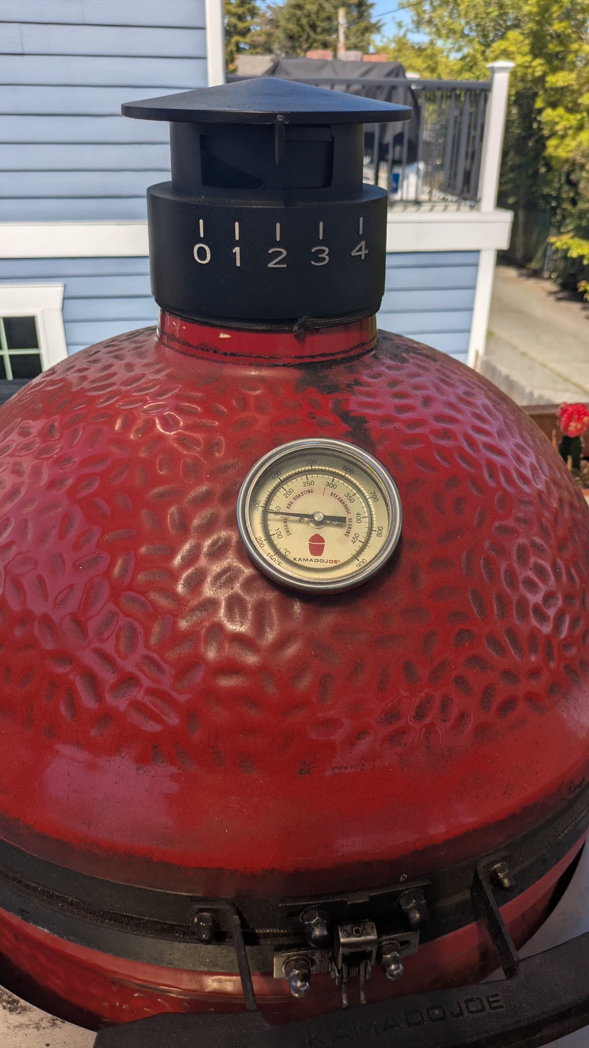 The Kamado Joe dome with the thermometer reading in medium territory